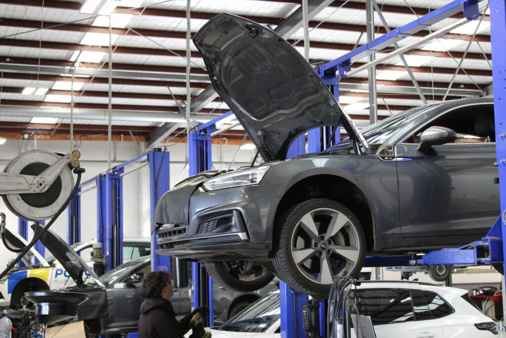 Robertson Prestige workshop grey car getting worked on by mechanic
